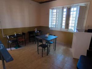 a dining room with tables and chairs and windows at Parvis Magna HOSTAL in Barraquero +5 photos