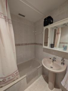 a bathroom with a sink and a bath tub and a sink at Casa Pilar Escarrilla Ski Views Parking Children Games Room in Escarrilla