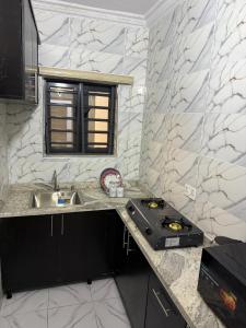 a kitchen with a sink and a stove at 9th House Apartments in Lagos +14 photos