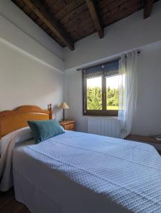 a bedroom with a bed and a window at Casa Pilar Escarrilla Ski Views Parking Children Games Room in Escarrilla +11 photos