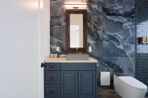 a bathroom with a blue vanity and a mirror at Scottsdale - 15322 N Sandy Bluff Rd-Casita - LUXE (No Bag) in Fountain Hills +26 photos
