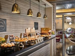 a bakery counter with pastries and breads on it at Mercure Roma Centro Colosseo in Rome
