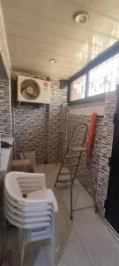 a room with a toilet and a chair and a window at marina house in Bordj el Bahri