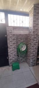 a room with a clock on a brick wall at marina house in Bordj el Bahri