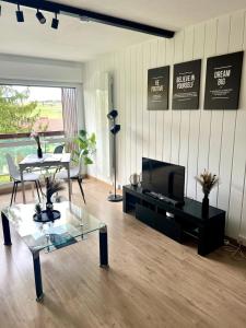 a living room with a tv and a coffee table at Studio cosy à Métabief in Métabief +8 photos