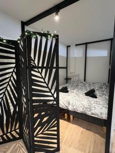 a bedroom with a bunk bed and a bed with lights at Studio cosy à Métabief in Métabief