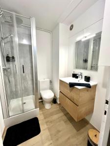 a bathroom with a shower and a toilet and a sink at Studio cosy à Métabief in Métabief