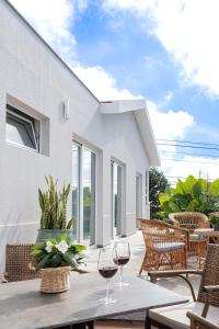 a patio with two glasses of wine on a table at Casa Graminho in Ponta do Sol