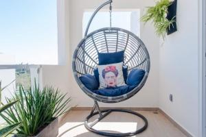 a swing chair with a pillow in a room at Casa Chavela10 Min Beach, Wifi 500 Mb, Gym, Pools in Playa del Carmen