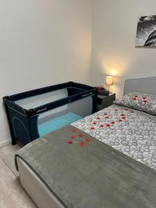 a bedroom with a large bed with red flowers on it at Vatican Stay Ottaviano in Rome