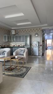 a living room with a couch and a table at شاليهات لودج in Al Humaizah