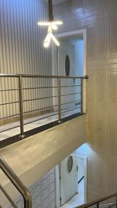 a room with a staircase and a ceiling fan at شاليهات لودج in Al Humaizah