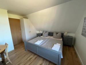 a bedroom with a large bed with two pillows at Doppelzimmer-Nigehoern in Baltrum