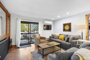 a living room with a couch and a table at Whispering Red Pine Paradise in Park City