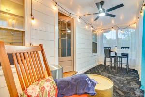 a screened in porch with a table and a ceiling fan at 2 Mi to Colby College Peaceful Home in Waterville in Waterville