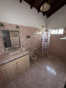 a bathroom with a sink and a toilet at Casa al rio con muelle privado Paso de la Patria in Paso de la Patria
