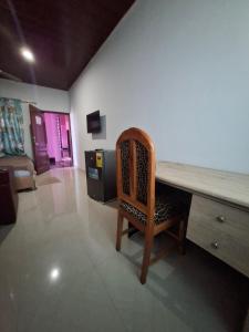 a room with a wooden desk and a chair at King'sol Guesthouse 