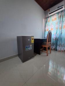 a room with a desk and a chair and a computer at King'sol Guesthouse 