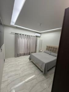 a bedroom with a bed and a skylight at Casa de 4 Quartos - 2 suites in Ananindeua