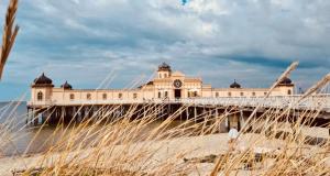 a pier with a building with a clock on it at Villa Margit ground floor apartment in Tvååker +21 photos