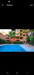 a picture of a swimming pool in front of a building at andlous 4 in Marrakech