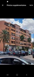 a large building with cars parked in front of it at andalous 4 in Marrakesh