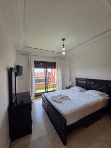 a bedroom with a large bed and a large window at andalous 4 in Marrakesh +10 photos