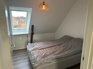 a bedroom with a bed and a window at 11F 2 TV Højbanetorvet in Vejle