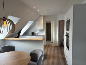 a kitchen with a table and chairs in a room at 11F 2 TV Højbanetorvet in Vejle