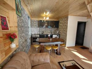a kitchen with a couch and a table in a room at Hilltop cottage Mestia in Mestia