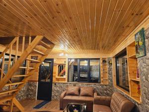 a living room with a staircase in a tiny house at Hilltop cottage Mestia in Mestia