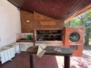 a kitchen with an oven and a table with a stove at Casa al rio con muelle privado Paso de la Patria in Paso de la Patria