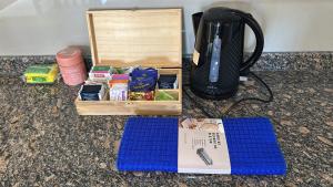 a table with a coffee maker and a box of food at Duplex en villa el chocon LO DE CARLITOS in Villa El Chocón
