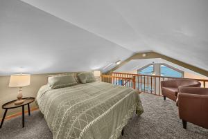 a bedroom with a bed and a balcony at Beach Front Houghton Lake with Game Room in Port Huron