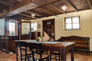 a dining room with a wooden table and chairs at Casa Del Grande Vecchio in Airasca