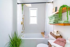 a bathroom with a white tub and a sink at Prime Location Top Rated Clean Parking Free! in Columbus +62 photos