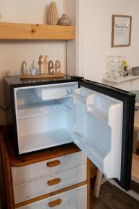 a refrigerator with its door open in a kitchen at Traumfänger in Heltersberg +9 photos