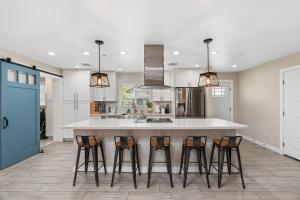 a kitchen with a large island with four bar stools at Closest Walk to Old Town, Entertainment District in Scottsdale