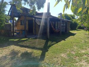 a house with a sprinkler in front of it at Pukará Reservas con depósito in Barra del Chuy