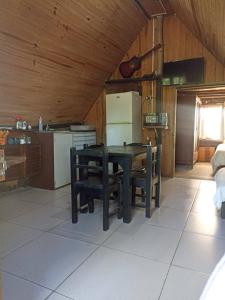 a kitchen with a table and chairs in a room at Pukará Reservas con depósito in Barra del Chuy