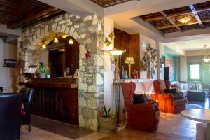 eine Lobby mit einem Steinkamin in einem Restaurant in der Unterkunft Pandion Luxury Boutique Hotel & Suites with Spa in Neochóri