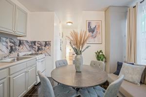 a kitchen with a table and chairs in a kitchen at Warm and Welcoming 2BR in Upper East Side in New York