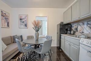 a kitchen and dining room with a table and chairs at Warm and Welcoming 2BR in Upper East Side in New York +9 photos
