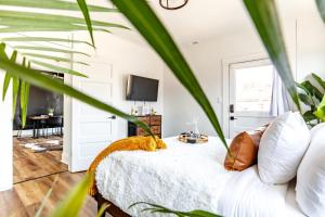 a bedroom with a white bed and a tv at Short North Convention Private Parking Pets! in Columbus