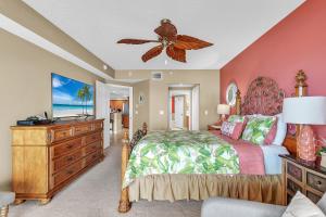 a bedroom with a bed and a ceiling fan at La Vistana #A503 in St Pete Beach +57 photos