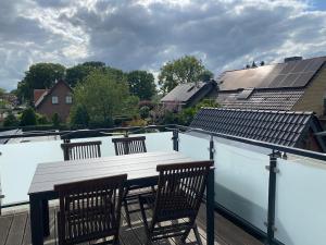a balcony with a table and chairs on a roof at Gemütliche Wohnung in Xanten