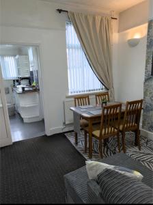 a kitchen and dining room with a table and chairs at City Vacations Kettering free WiFi for ' Short & Long stays ' Shared bathroom & Shared Kitchen Double room for 1 - 2 Adults in Kettering