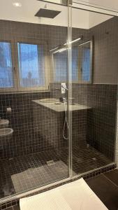 a glass shower in a bathroom with two sinks at Blue Tao Maison Taormina in Taormina +41 photos