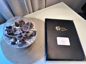 un livre et un bol de fruits sur une table dans l'établissement Stellina Apartment beim Europa Park Rust, à Rust 7 autres photos
