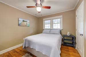 a bedroom with a bed and a ceiling fan at Walk to Frog Level Historic District! Home with Deck in Waynesville